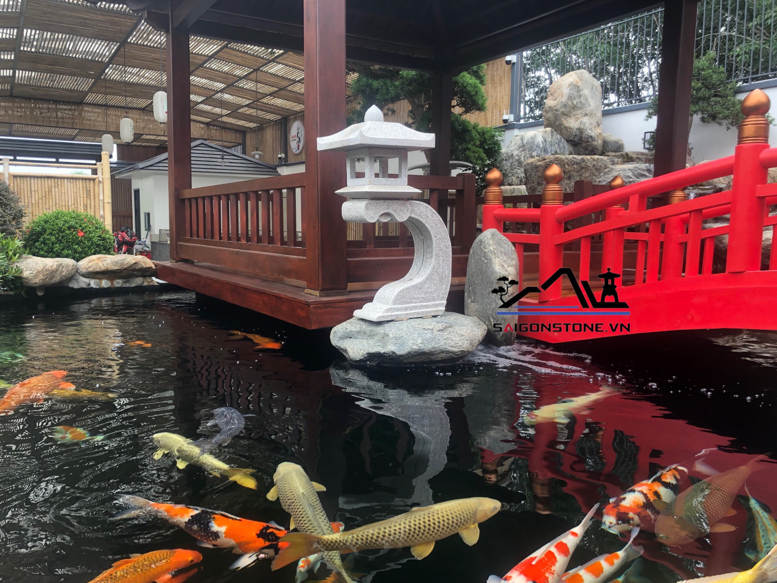 Đèn đá sân vườn được đặt trong hồ cá Koi tạo nên không gian yên bình và thư thái